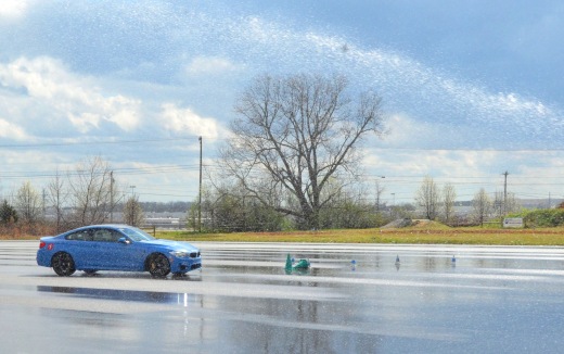 Kim navigates the Figure 8 course as the sprinklers keep the pavement wet